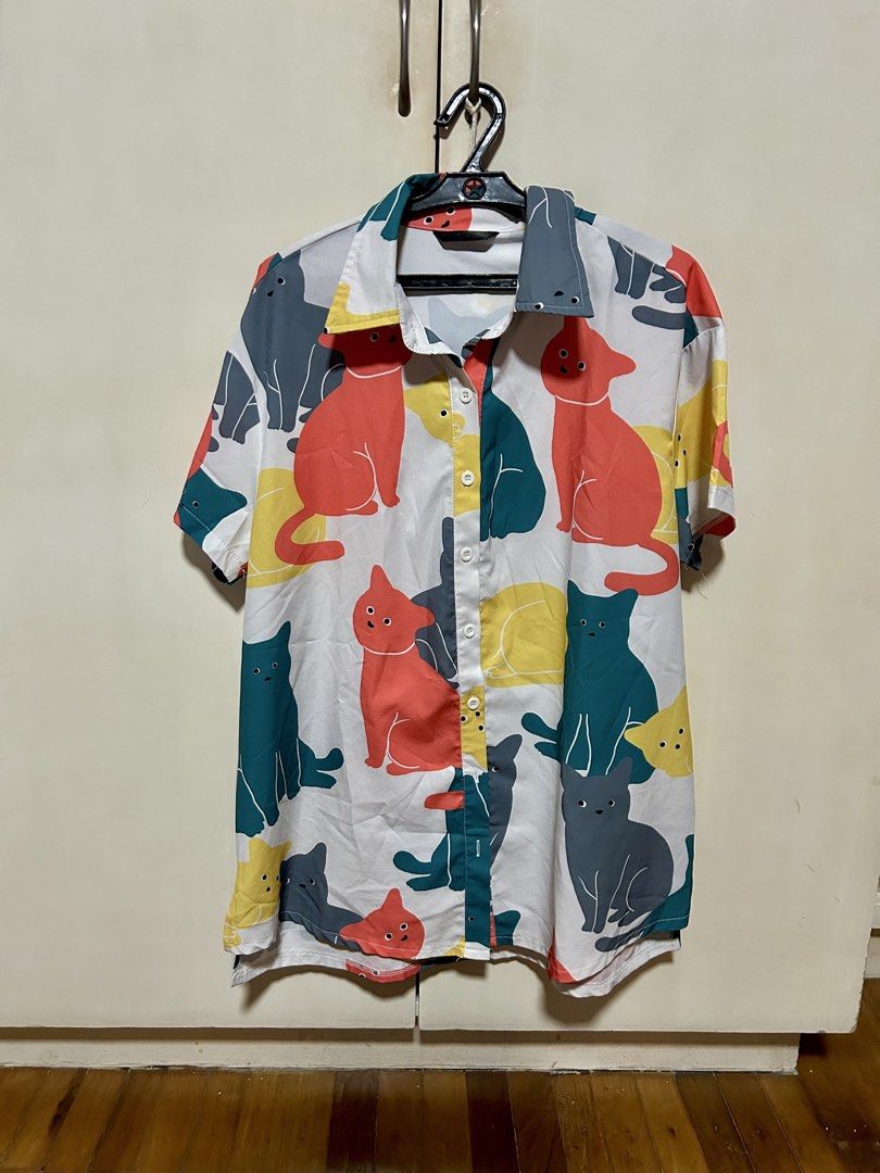 Cat Print Short Sleeve Button Down Shirt (Category: Shirts) located in Makati City. Submitted by monicavazquez (Listing ID 1465485949, Image 1). Description: Fun and quirky short sleeve button-down shirt with a colorful cat pattern, camp collar, and lightweight fabric for casual wear. Standard fit..