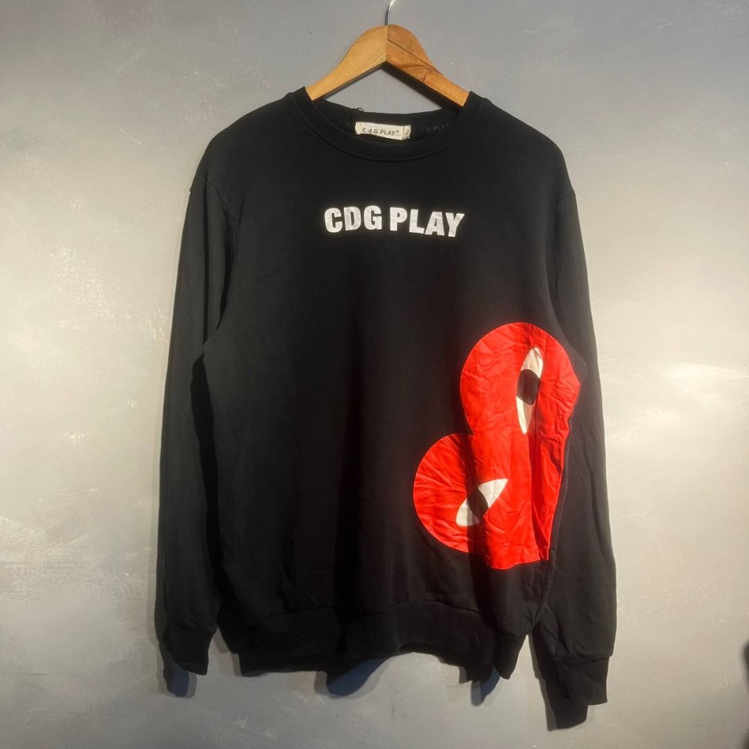 CDG Play Sweatshirt (Category: Coats, Jackets and Outerwear) located in Mariveles. Submitted by akidfromnowherethrift (Listing ID 1465487226, Image 1). Description: Cdg Play Dimes: 22x27 Size: L Color rate: 10/10 Condition: Excellent Condition.