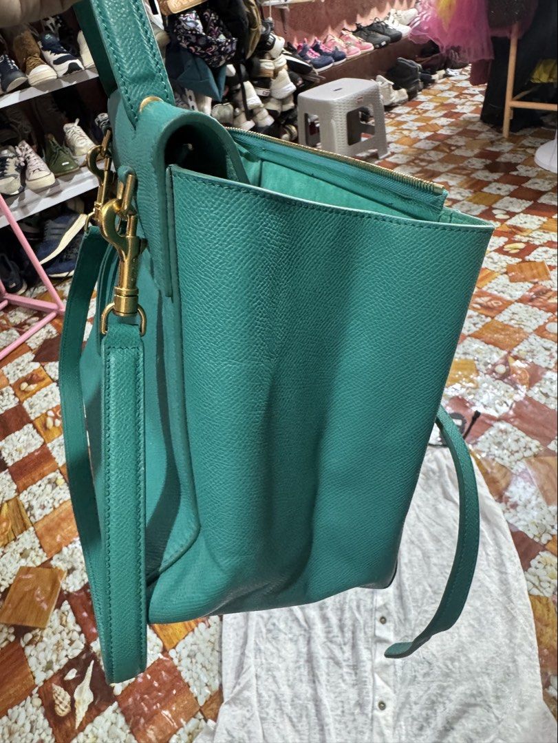 Celine Cross Body Bag 100% Genuine (Category: Luxury Bags & Wallets) located in Manila. Submitted by wildbear.e10374 (Listing ID 1453886635, Image 3). Description: - Genuine turquoise leather Celine bag - Textured leather exterior - Elegant gold hardware details on the bottom - Interior zipper pocket for essentials - Crafted in Italy - color dark green/hardware gold celine Paris . With sling can TOP handle or Cross body .with zipper ..