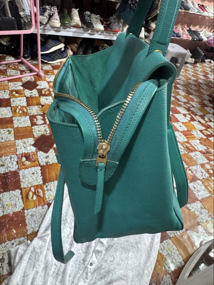 Celine Cross Body Bag 100% Genuine (Category: Luxury Bags & Wallets) located in Manila. Submitted by wildbear.e10374 (Listing ID 1453886635, Image 2). Description: - Genuine turquoise leather Celine bag - Textured leather exterior - Elegant gold hardware details on the bottom - Interior zipper pocket for essentials - Crafted in Italy - color dark green/hardware gold celine Paris . With sling can TOP handle or Cross body .with zipper ..
