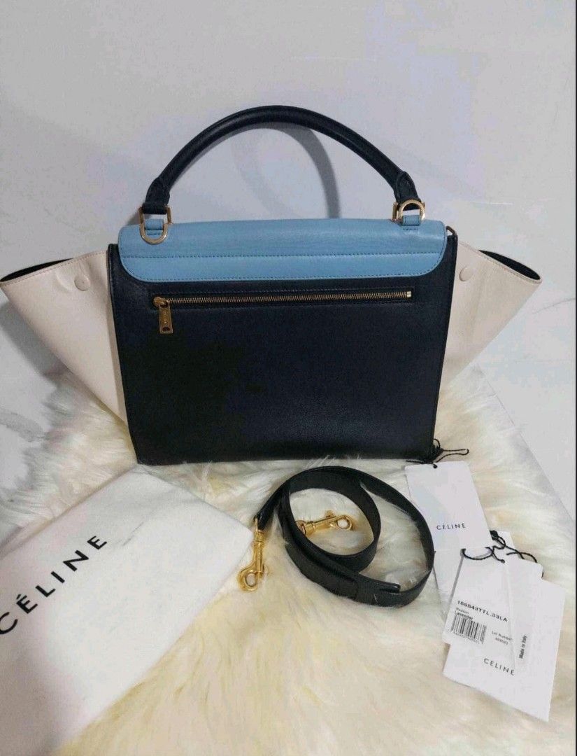 Celine Trapeze Tricolor Leather Bag (Category: Luxury Bags & Wallets) located in Cainta. Submitted by mmusaimports (Listing ID 1465492138, Image 3). Description: - Authentic Celine Trapeze bag in tricolor leather (blue, black, and cream) - Features a rolled top handle and a removable shoulder strap - Gold-tone hardware closure and convenient back zipper pocket - Includes original dust bag and product tags - Meet-ups and shipping available across 