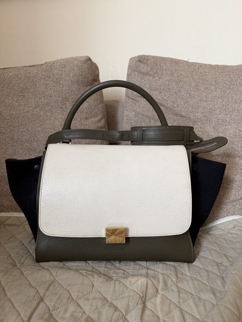 Celine Tricolor Trapeze Bag (Category: Luxury Bags & Wallets) located in Manila. Submitted by gcgarcia (Listing ID 1465416269, Image 1). Description: - Brand: Celine - Style: Trapeze Bag - Colorway: Tricolor (Olive Green, White, Dark Blue) - Features: Structured top handle, detachable shoulder strap - Hardware: Gold-tone with Celine logo stamps (clasp, zipper pulls, strap clasps) - Interior: Gold embossed Celine Paris Made in Italy stamp near the