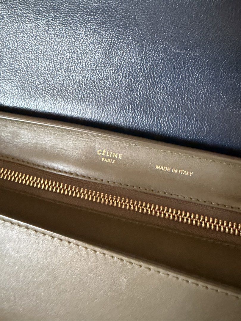 Celine Tricolor Trapeze Bag (Category: Luxury Bags & Wallets) located in Manila. Submitted by gcgarcia (Listing ID 1465416269, Image 3). Description: - Brand: Celine - Style: Trapeze Bag - Colorway: Tricolor (Olive Green, White, Dark Blue) - Features: Structured top handle, detachable shoulder strap - Hardware: Gold-tone with Celine logo stamps (clasp, zipper pulls, strap clasps) - Interior: Gold embossed Celine Paris Made in Italy stamp near the