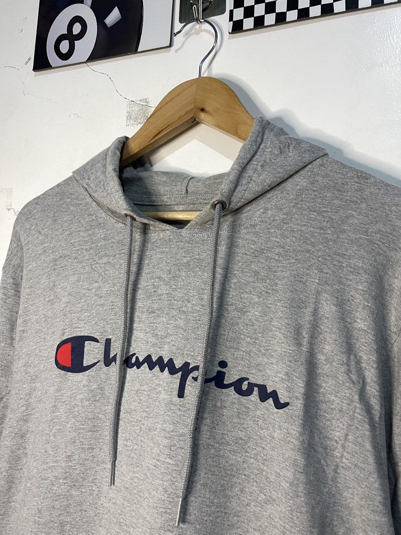 Champion grey script logo hoodie XL (Category: Hoodies) located in Cabagan. Submitted by blessingma81004 (Listing ID 1465401855, Image 3). Description: Grey Champion hoodie with cursive script logo across the chest. Drawstring hood, kangaroo pocket, ribbed cuffs and hem. Small Champion C patch embroidery on the left sleeve. 100 percent cotton, made in Cambodia. Relaxed fit, tag size XL, flat measurements W21xL30 inches. No flaws or damage found, 
