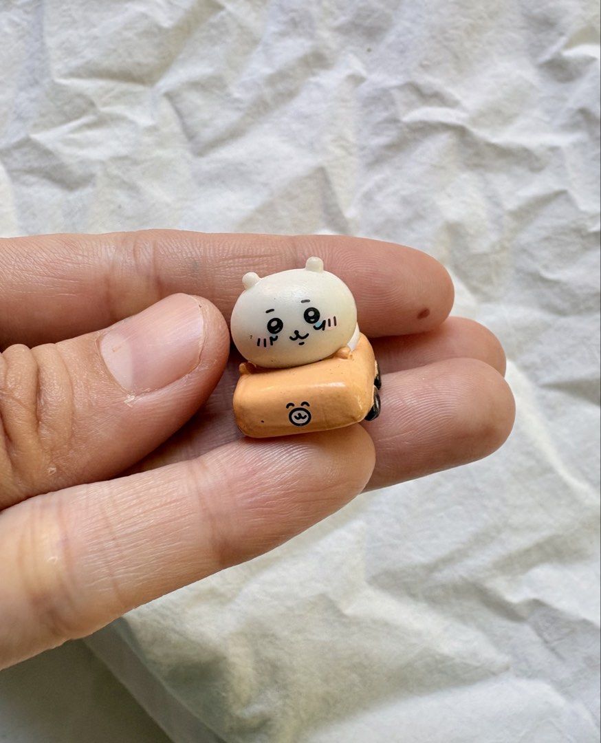Chiikawa Nagano Car Figurine (Category: Vehicle & Diecast Models) located in Tuguegarao City. Submitted by jasminecoll (Listing ID 1465537294, Image 1). Description: - Official Chiikawa collectible figure in an orange toy car - Genuine Nagano copyright stamped on the bottom - Adorable hand-painted facial expression and details - Miniature handheld size (just a few centimeters long) - Perfect gift or addition to any Chiikawa collection! -Location 