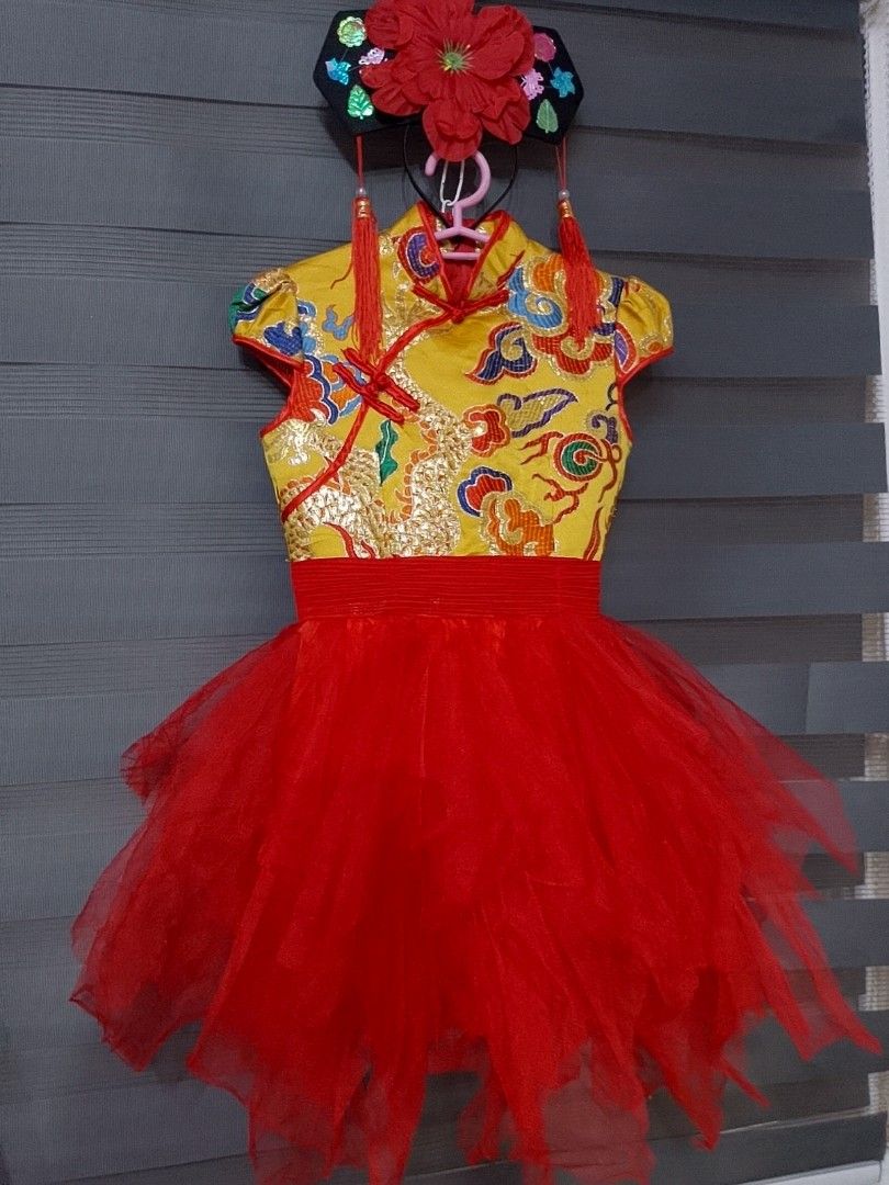 CHINESE / UN COSTUME (Category: Babies & Kids Fashion) located in Pasig City. Submitted by sweetchinchin15 (Listing ID 1465392634, Image 1). Description: - Style: Traditional Chinese children's dress - Design: Bright yellow top with gold dragon and cloud embroidery, red Mandarin collar, and frog buttons - Skirt: Fluffy layered red tulle skirt attached at the waist - Accessory: Matching black hairpiece with big red flower and hanging tassels inclu