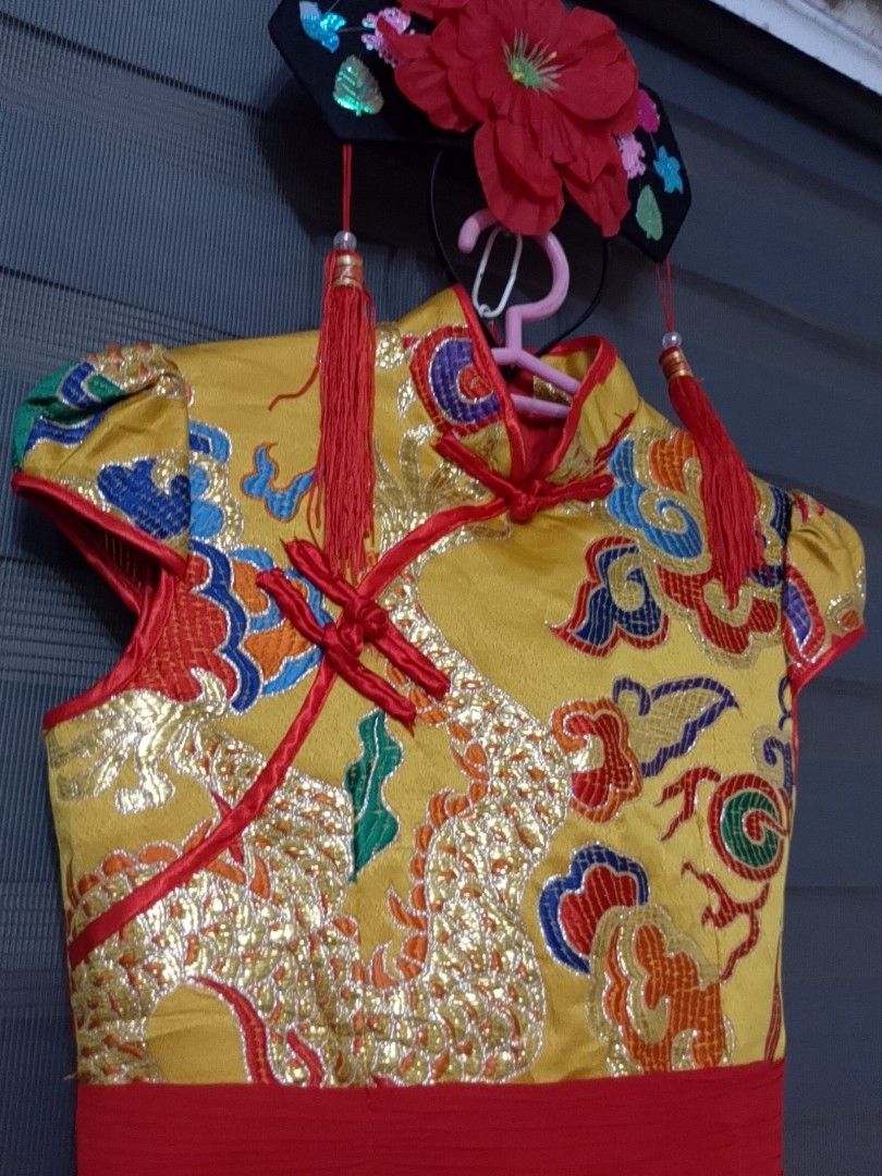 CHINESE / UN COSTUME (Category: Babies & Kids Fashion) located in Pasig City. Submitted by sweetchinchin15 (Listing ID 1465392634, Image 2). Description: - Style: Traditional Chinese children's dress - Design: Bright yellow top with gold dragon and cloud embroidery, red Mandarin collar, and frog buttons - Skirt: Fluffy layered red tulle skirt attached at the waist - Accessory: Matching black hairpiece with big red flower and hanging tassels inclu
