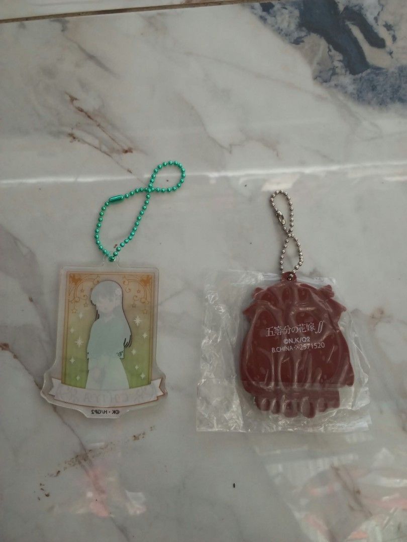 Chiya and Nino Anime Keychains (Category: Character Goods) located in Davao. Submitted by mengsmixitems (Listing ID 1465426854, Image 2). Description: - Set of 2 anime keychains sold together - Chiya: Acrylic plate with green ball chain - Nino (Quintessential Quintuplets): Swimsuit design, brand new inside clear packaging with silver ball chain - Condition: Clean and intact - Perfect for anime merch collectors.