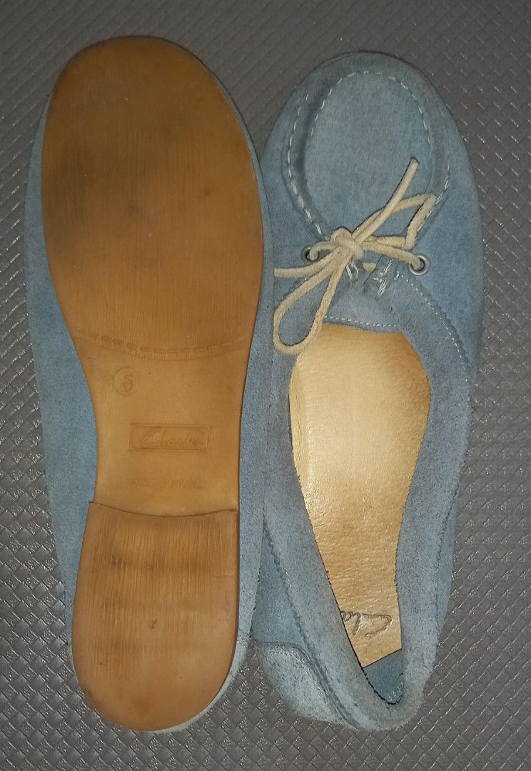 Clarks Blue Suede Moccasin Flats (Category: Loafers) located in Cagayan de Oro. Submitted by edwardryan01984 (Listing ID 1465416942, Image 3). Description: - Brand: Clarks - Style: Light blue suede slip-on shoes with front tie detail - Origin: Made in Portugal - Size: UK/US 5 - Features: Flat soles with a slight heel, comfortable leather insoles (note: insoles show visible wear) - Condition: Pre-loved, well-kept.