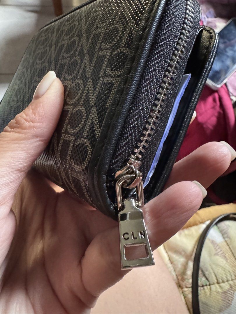 CLN Black Monogram Pattern Compact Wallet (Category: Wallets & Card holders) located in Pasig City. Submitted by oinkrowie (Listing ID 1465498233, Image 3). Description: - Brand: CLN - Color: Classic black with all-over monogram pattern - Closure: Snap tab with silver hardware and wrap-around zip - Compartments: Multiple card slots, clear ID window, and a secure coin/cash section - Details: Clean lining, sturdy branded zipper pull - Fit: Practica