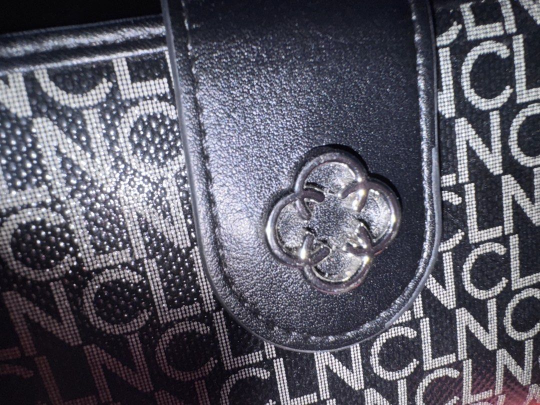 CLN Black Monogram Pattern Wallet (Category: Wallets & Card holders) located in Pasig City. Submitted by rowie_08 (Listing ID 1465516920, Image 2). Description: CLN black wallet with an all-over monogram print. Snap button closure featuring a clover metal accent on the front tab. Includes a zip-around compartment with an accordion card holder section inside. Plenty of slots to keep cards and cash organized. Silver-tone hardware throughout with br