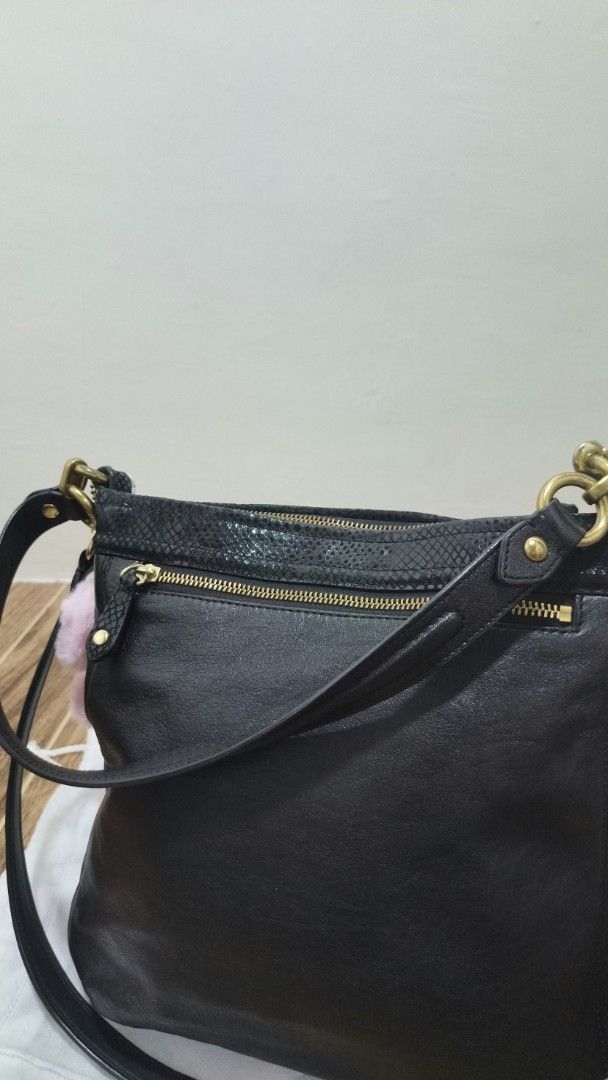 Coach Black Leather Shoulder Bag (Category: Luxury Bags & Wallets) located in Pasig City. Submitted by willselleverything.27 (Listing ID 1465488999, Image 3). Description: - Brand: Coach - Color: Black with snakeskin trim and gold-tone hardware - Style: Slouchy hobo shoulder bag with pleated front - Closure: Secure top zipper plus an extra back zip pocket - Strap: Includes a detachable strap for versatile wear - Bonus: Comes with an adorable fluf