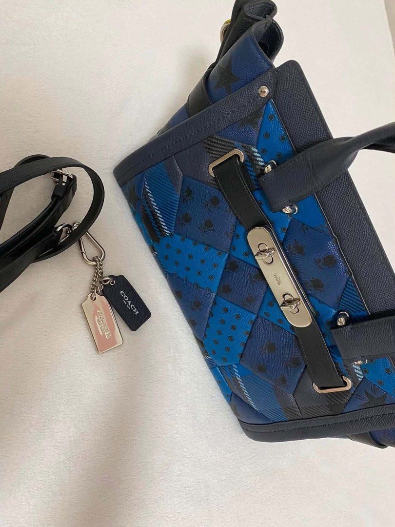 Coach Blue Patchwork Leather Satchel Bag (Category: Luxury Bags & Wallets) located in Pasig City. Submitted by preloved.by.patsy (Listing ID 1465479115, Image 3). Description: - Comes with receipt and authenticity card - Brand: Coach Satchel - Color: Dark blue tones with a mixed patchwork pattern (floral, polka dots, checks) - Features: Double top handles, adjustable/detachable shoulder strap, and front flap turnlock closure - Hardware & Accents: