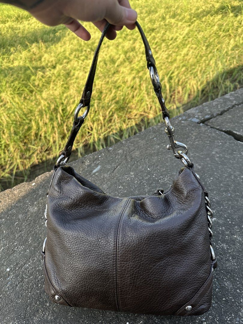 Coach Carly Choco Brown Medium Size with Silver Hardware (Category: Luxury Bags & Wallets) located in Manila. Submitted by glesylbd_22 (Listing ID 1465396881, Image 2). Description: - Brand: Coach - Style: Leather hobo bag - Color: Dark brown with pebbled texture - Hardware: Silver-tone links and accents - Closure: Secure zip top - Inclusions: Matching hangtag on a beaded chain - Interior: Clean lining - Condition: Good everyday size, well-mainta