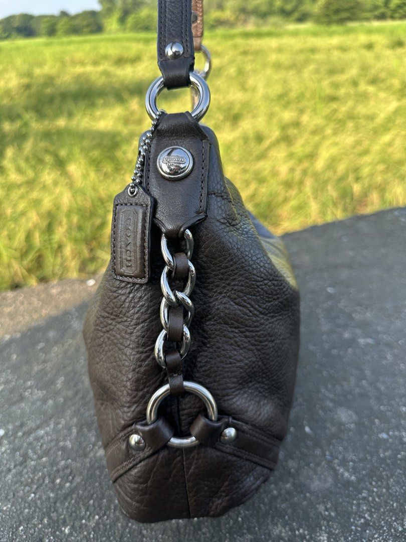 Coach Carly Choco Brown Medium Size with Silver Hardware (Category: Luxury Bags & Wallets) located in Manila. Submitted by glesylbd_22 (Listing ID 1465396881, Image 3). Description: - Brand: Coach - Style: Leather hobo bag - Color: Dark brown with pebbled texture - Hardware: Silver-tone links and accents - Closure: Secure zip top - Inclusions: Matching hangtag on a beaded chain - Interior: Clean lining - Condition: Good everyday size, well-mainta