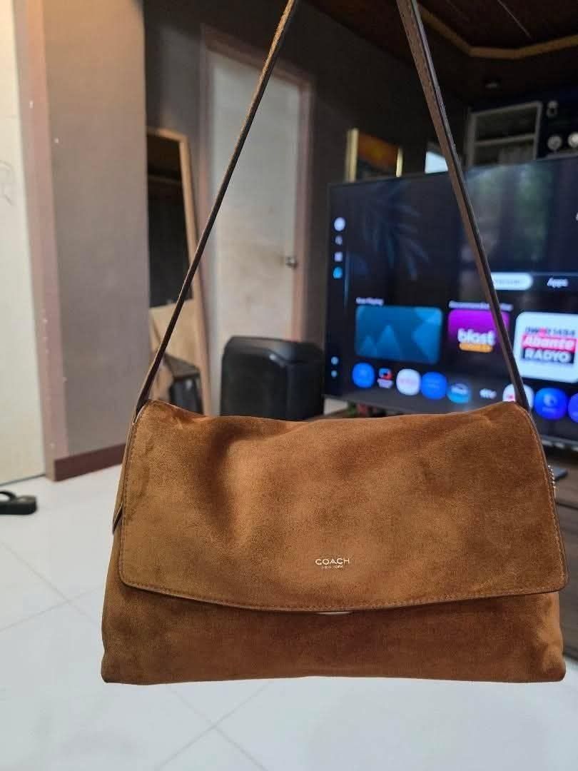 Coach Chelsea 30 (Category: Luxury Bags & Wallets) located in Cagayan de Oro. Submitted by truetiger.888c64 (Listing ID 1465409056, Image 1). Description: - Authentic Coach brown suede shoulder bag - Flap closure with chic gold-toned front lettering - Clean and soft suede texture throughout - Comes with a comfortable attached strap - Versatile neutral earth tone, perfect for daily casual outfits.