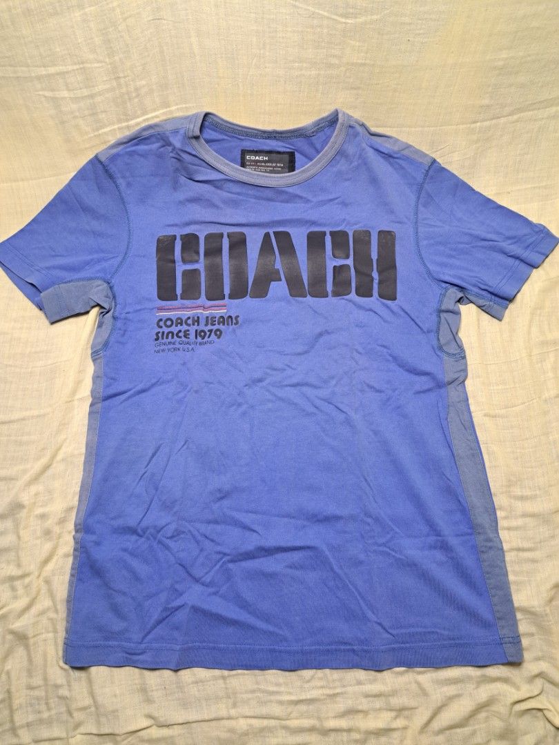 Coach Jeans Blue T-shirt Size M (Category: Shirts) located in Manila. Submitted by sainty.exe (Listing ID 1465455457, Image 1). Description: - Brand: Coach Jeans - Color: Blue - Size: Medium (Tag attached) - Material: Soft cotton - Design: 'Coach Jeans Since 1979' front graphic, number 8 back print - Details: Crew neck with ribbed collar, contrasting shoulder and side panels - Condition: Brand new with tag / Excellent pre-loved (Ready to wear).