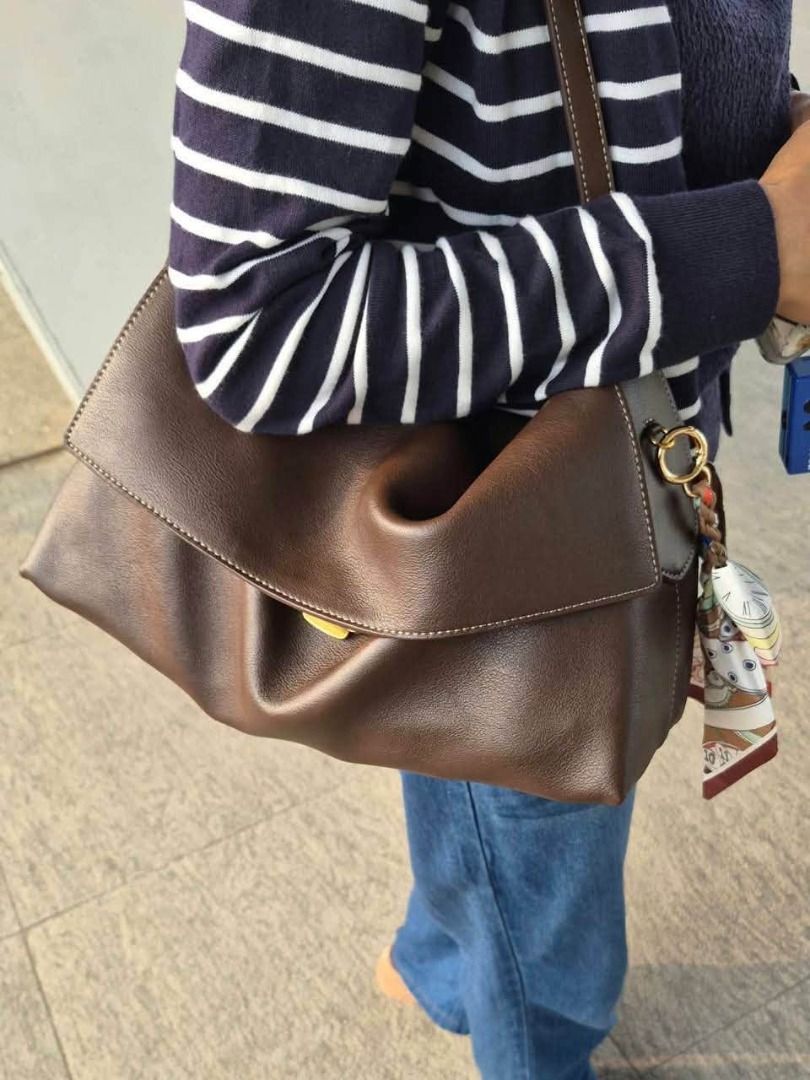 Coach Leather Flap Shoulder Bag Black and Brown (Category: Shoulder Bags) located in Manila. Submitted by liahsells (Listing ID 1465462184, Image 1). Description: - Brand: Coach - Material: Smooth leather with contrast stitching - Available in 30cm and 35 CM - Design: Structured flap with secure magnetic closure and gold-tone logo lettering - Straps: Long and adjustable for shoulder or crossbody wear - Interior: Clean lining with multiple pieces 