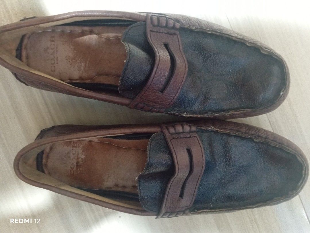 Coach Leather Penny Loafers (Category: Loafers) located in Sariaya. Submitted by angelochintes732 (Listing ID 1465467077, Image 1). Description: - Brand: Coach - Style: Two-tone leather penny loafers / slip-on moccasins - Color: Dark main body with brown strap detail - Features: Comfortable daily footwear with interior branding.