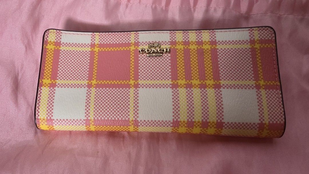Authentic Plaid Long Wallet Pink Yellow White (Category: Wallets & Card holders) located in Manila. Submitted by a.sta.ana13 (Listing ID 1465402663, Image 1). Description: The funds raise here will go straight to my aunt’s medical expenses - Brand: Coach - Design: Pink, yellow, and white plaid pattern with clean dark edging - Hardware: Gold-tone Coach New York logo on front - Style: Structured rectangular long wallet with flap closure - Condition