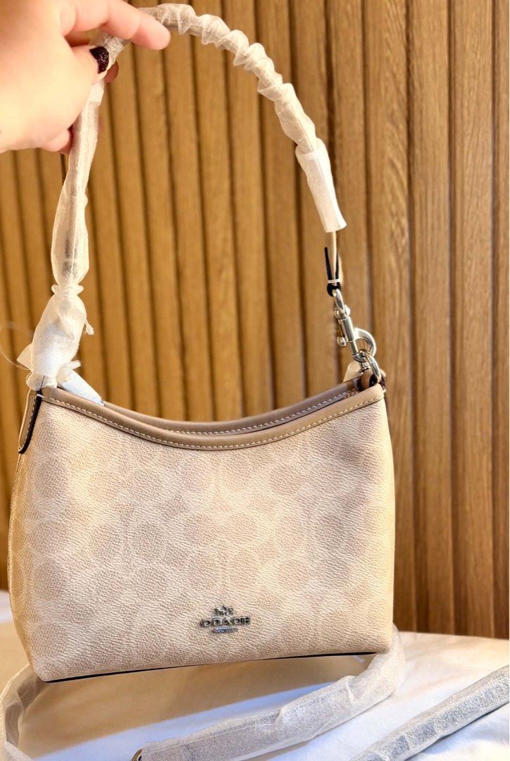 Coach Signature Beige Shoulder Bag (Category: Luxury Bags & Wallets) located in Manila. Submitted by iamsassycl95926 (Listing ID 1465476301, Image 2). Description: - Brand: Coach - Color: Light beige with signature monogram pattern - Hardware: Silver-tone with front logo lettering - Condition: Brand new with handles and extra strap still wrapped in protective plastic - Design: Clean structure, versatile neutral tone that matches any outfit - Incl