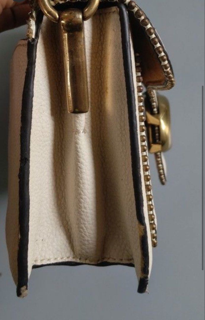 Coach Tabby Shoulder Bag White With Brass Hardware (Category: Luxury Bags & Wallets) located in Makati City. Submitted by kaydecluttersss (Listing ID 1465387132, Image 3). Description: - Brand: Coach - Style: Structured shoulder bag with top handle with detachable shoulder strap - Material: Off-white pebble grain leather with luxurious brown suede lining - Hardware: Antiqued brass with signature C pushlock closure and bead chain trim - Interior: 