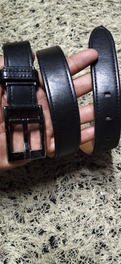 COMME CA DU MODE Men pure Black Leather Belt (Category: Belts) located in Paranaque City. Submitted by michael-08 (Listing ID 1465390369, Image 1). Description: - Brand: Comme Ca Du Mode Men - Material: Genuine black leather with tan inner lining - Design: Stitched edges and silver-tone rectangular buckle - Condition: Visible scratches on the buckle from regular wear - Features: Multiple adjustment holes for a customized fit - Style: Classic ever