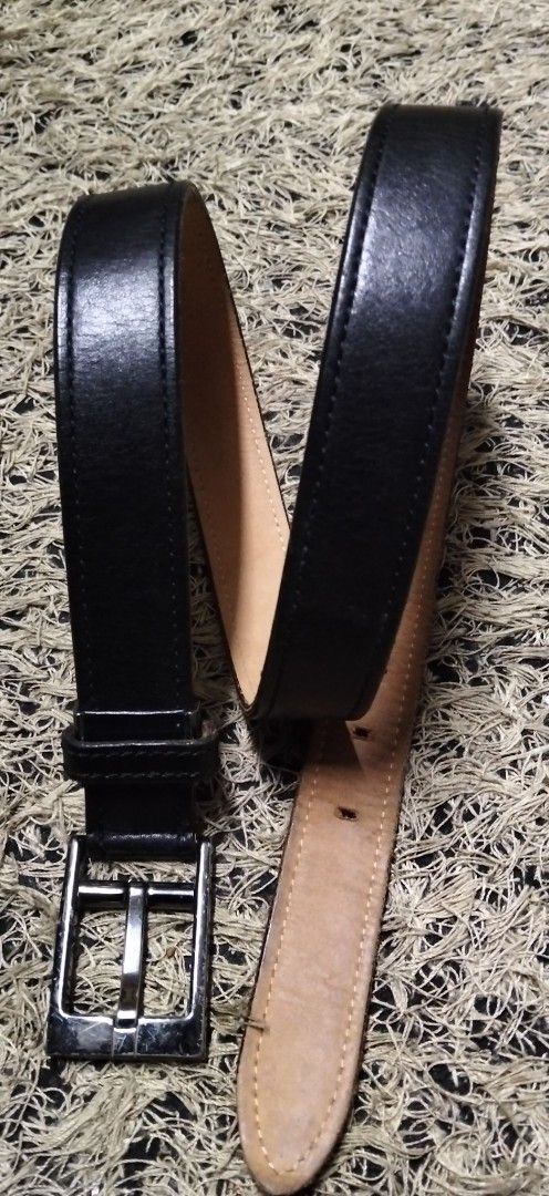 COMME CA DU MODE Men pure Black Leather Belt (Category: Belts) located in Paranaque City. Submitted by michael-08 (Listing ID 1465390369, Image 3). Description: - Brand: Comme Ca Du Mode Men - Material: Genuine black leather with tan inner lining - Design: Stitched edges and silver-tone rectangular buckle - Condition: Visible scratches on the buckle from regular wear - Features: Multiple adjustment holes for a customized fit - Style: Classic ever