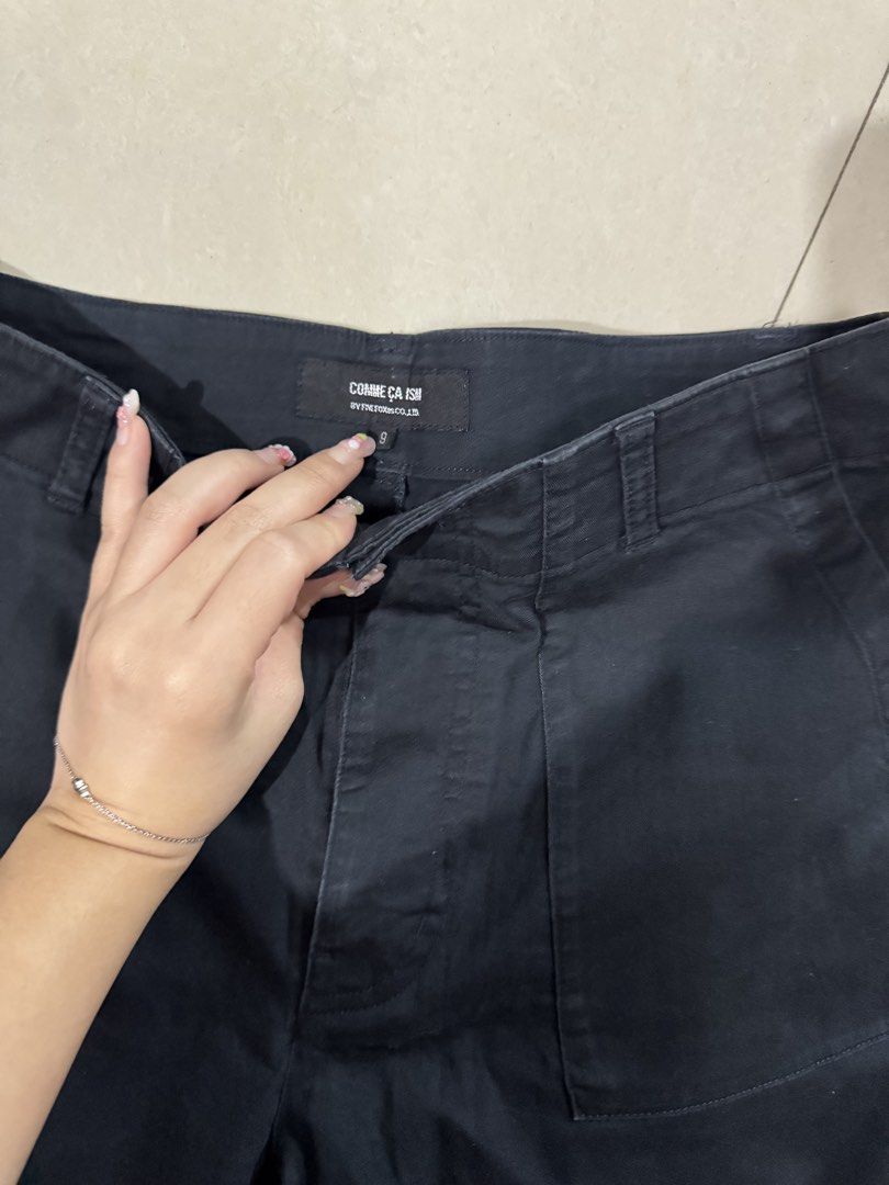 Comme Ca Ism Black Utility Pants Size 9 (Category: Trousers) located in Quezon City. Submitted by sweetlyluxe (Listing ID 1465491414, Image 3). Description: - Brand/Model: Comme Ca Ism black utility pants - Size: Tagged size 9 fits up to semi M - Fit: Mid-rise waist with a straight wide-leg cut - Pockets: Large front patch pockets and buttoned flap back pockets - Closure: Front button closure - Condition: Minimal wear, clean, and ready to wear.