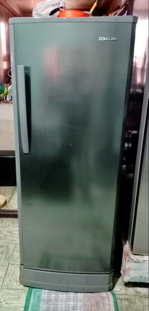 Condura Single Door Refrigerator (Category: Refrigerators and Freezers) located in Manila. Submitted by newocean.42ee53 (Listing ID 1465392779, Image 1). Description: - Brand/Model: Condura Single Door Refrigerator - Color: Grey finish - Interior: Dedicated freezer, chiller compartment, wire shelves, and bottom crisper drawer - Door Storage: Slots for eggs, butter, jars, and big bottles - Features: Adjustable temperature control knob - Condition: