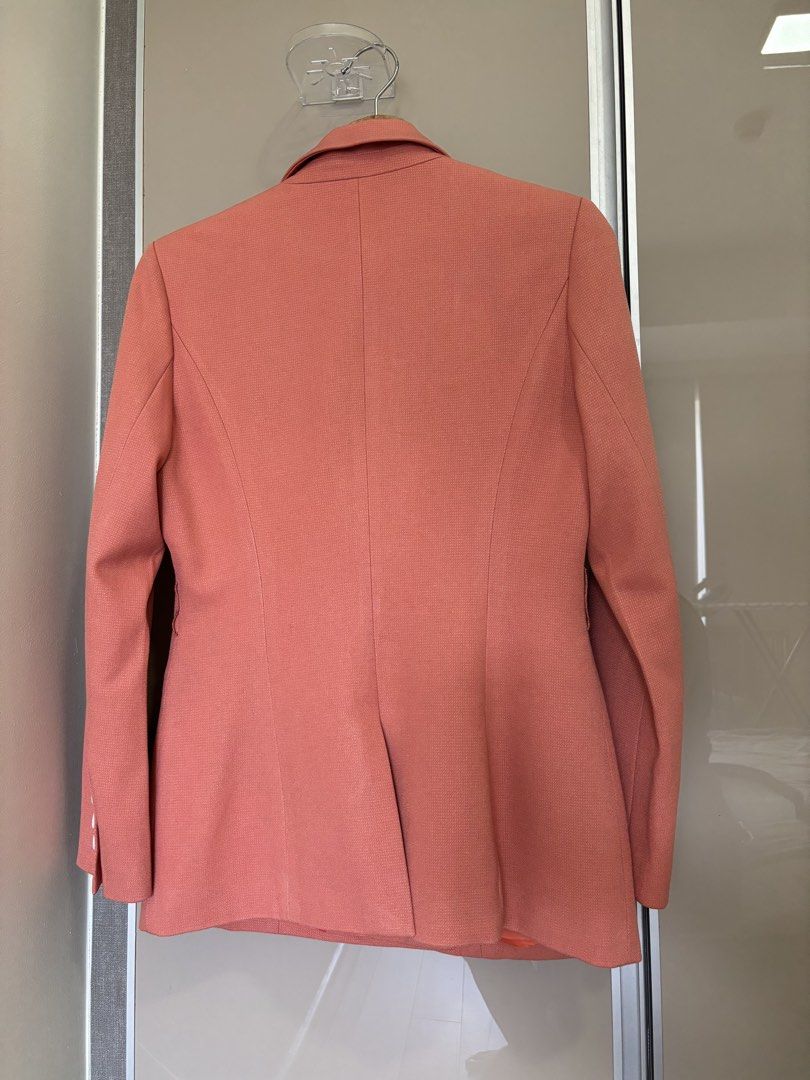 Coral Structured Double-Breasted Blazer (Category: Coats, Jackets and Outerwear) located in Pasay City. Submitted by mommapauie (Listing ID 1465449908, Image 3). Description: - Color: Coral with a vibrant orange lining - Style: Double-breasted blazer with structured lapels - Size: Medium (fits upto large) - Features: Front button closure, front flap pockets and 3 decorative cuff button - Versatility: Great for professional workwear or stylish cas