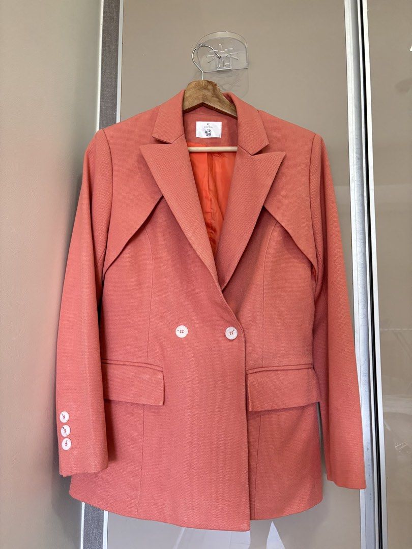 Coral Structured Double-Breasted Blazer (Category: Coats, Jackets and Outerwear) located in Pasay City. Submitted by mommapauie (Listing ID 1465449908, Image 1). Description: - Color: Coral with a vibrant orange lining - Style: Double-breasted blazer with structured lapels - Size: Medium (fits upto large) - Features: Front button closure, front flap pockets and 3 decorative cuff button - Versatility: Great for professional workwear or stylish cas