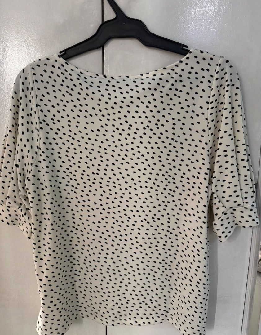 H&M Cream and black polka dot blouse (Category: Blouses) located in Santa Rosa. Submitted by biancamarie0404 (Listing ID 1465435361, Image 2). Description: - Cream blouse with small black polka dots - Elegant boat neckline and half sleeves with cuffed hems - Lightweight, easy pullover style - Versatile piece for work or casual wear - Clean condition, no obvious flaws.