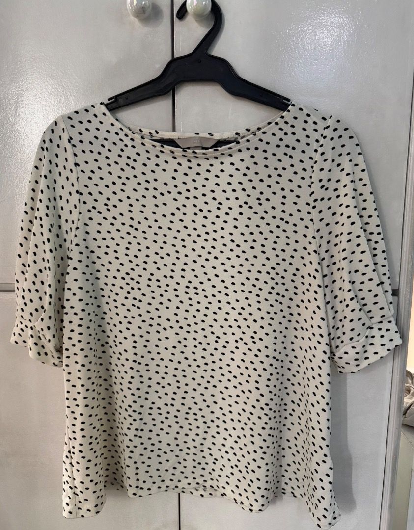 H&M Cream and black polka dot blouse (Category: Blouses) located in Santa Rosa. Submitted by biancamarie0404 (Listing ID 1465435361, Image 1). Description: - Cream blouse with small black polka dots - Elegant boat neckline and half sleeves with cuffed hems - Lightweight, easy pullover style - Versatile piece for work or casual wear - Clean condition, no obvious flaws.