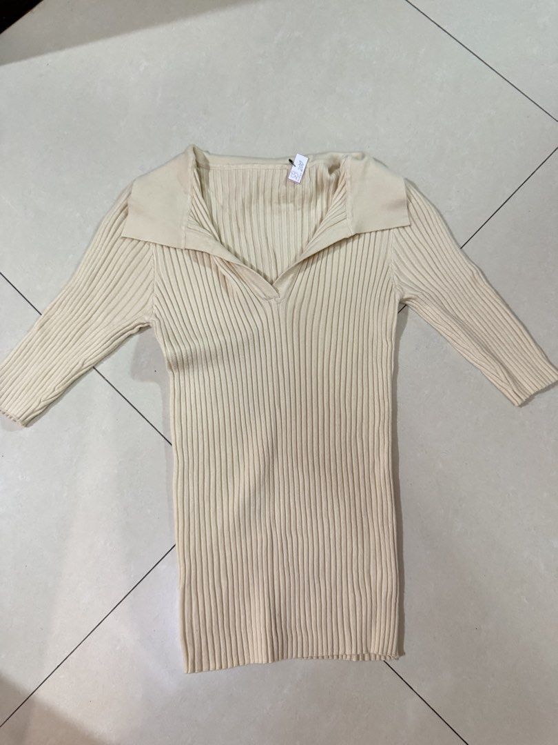 Cream Ribbed Knit Collared V-Neck Top (Category: Longsleeves) located in Quezon City. Submitted by sweetlyluxe (Listing ID 1465496841, Image 1). Description: - Color: Cream - Style: Ribbed knit top with collar and V-neckline - Fit: Fitted cut with long sleeves - Material: Soft and stretchy fabric - Condition: Brand new with tag still attached - Versatile: Easy to match with jeans or skirts for officef corporate work.