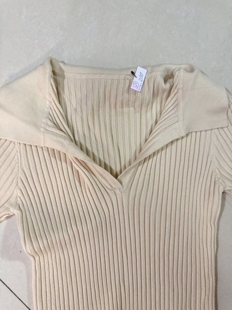 Cream Ribbed Knit Collared V-Neck Top (Category: Longsleeves) located in Quezon City. Submitted by sweetlyluxe (Listing ID 1465496841, Image 2). Description: - Color: Cream - Style: Ribbed knit top with collar and V-neckline - Fit: Fitted cut with long sleeves - Material: Soft and stretchy fabric - Condition: Brand new with tag still attached - Versatile: Easy to match with jeans or skirts for officef corporate work.