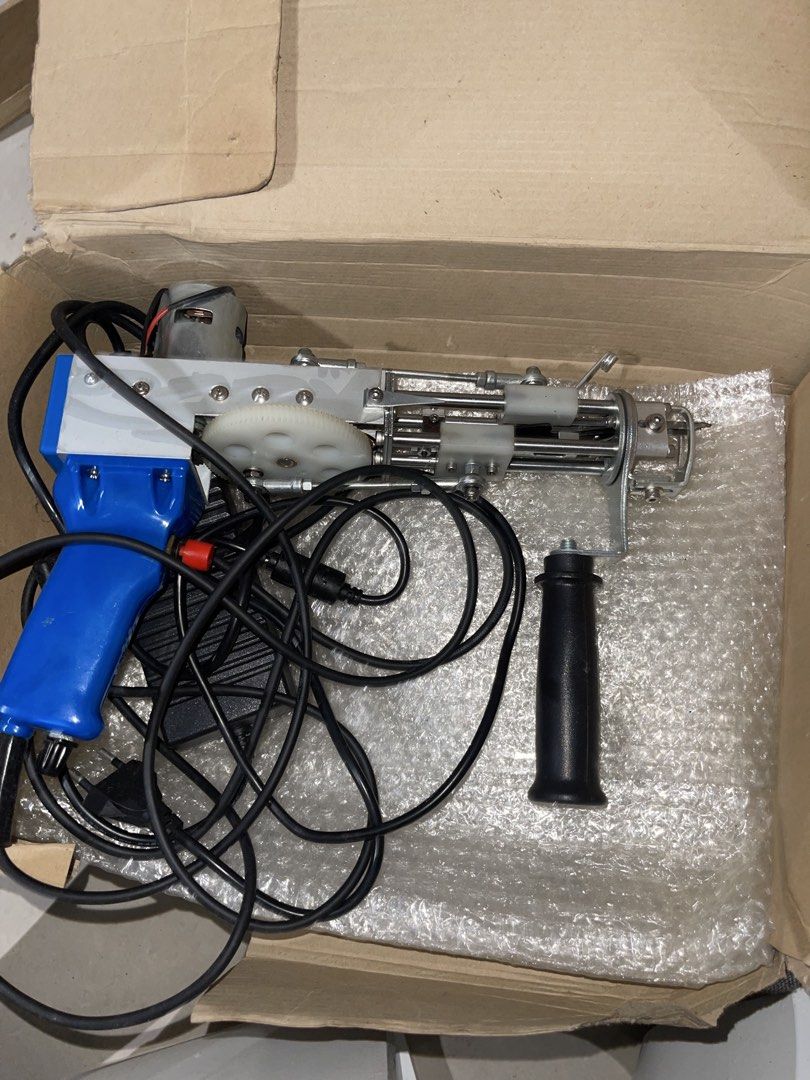Cut Pile Tufting Gun Carpet Weaving Machine (Category: Home Improvement Tools & Accessories) located in Mandaluyong City. Submitted by lluisl (Listing ID 1465459870, Image 1). Description: - Type: Electric Tufting Gun (Cut Pile) - Color: Blue and silver with white gear - Inclusions: Power cord and separate handle attachment - Packaging: Securely packed in a cardboard box - Condition: Brand new and ready to use - Ideal for: DIY rugs, carpets, and 