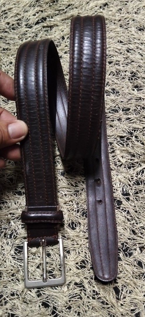 Dark Brown Leather Belt with Silver Buckle (Category: Belts) located in Paranaque City. Submitted by michael-08 (Listing ID 1465402973, Image 2). Description: - Color: Dark brown - Material: Genuine leather with stitched detailing - Hardware: Silver-toned metal buckle (with noticeable fading and wear) - Features: Multiple adjustment holes and intact loop holder - Condition: Pre-loved, solid everyday accessory WALA PO ISSUE GOOD CONDITION BODY WAI