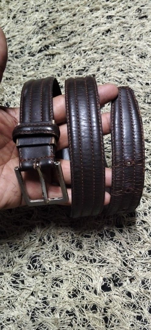 Dark Brown Leather Belt with Silver Buckle (Category: Belts) located in Paranaque City. Submitted by michael-08 (Listing ID 1465402973, Image 1). Description: - Color: Dark brown - Material: Genuine leather with stitched detailing - Hardware: Silver-toned metal buckle (with noticeable fading and wear) - Features: Multiple adjustment holes and intact loop holder - Condition: Pre-loved, solid everyday accessory WALA PO ISSUE GOOD CONDITION BODY WAI