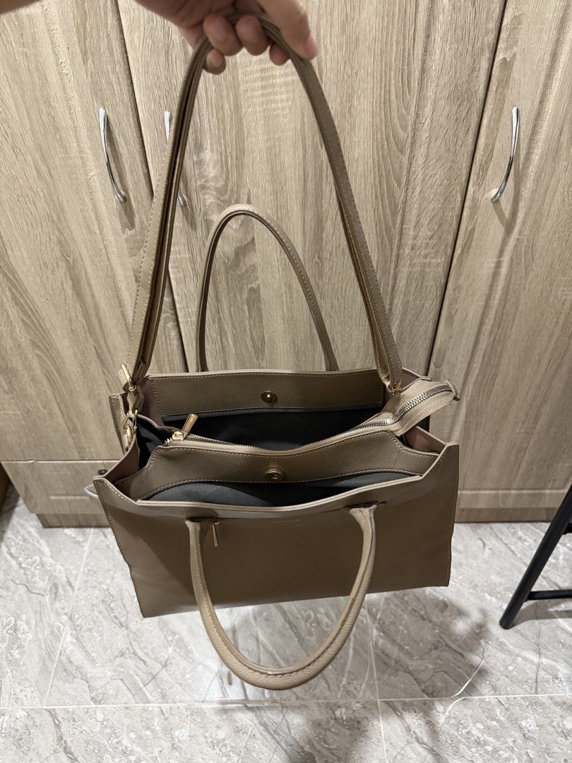 David Jones Paris Tote Shoulder Bag With Compartments (Category: Tote Bags) located in Calamba. Submitted by nicalison (Listing ID 1465424588, Image 3). Description: - Brand: David Jones Paris - Style: Tote / Shoulder Bag - Color: Taupe / Greyish Brown - Material: Textured synthetic leather with gold-tone hardware - Compartments: Multiple interior compartments with secure zip and magnetic button closures - Handles: Dual top carry handles plus an 