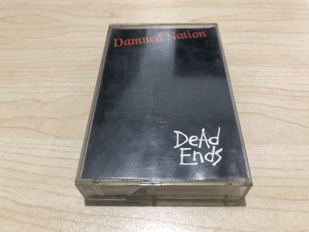Dead Ends - Damned Nation Cassette Tape (Category: CDs & DVDs) located in Manila. Submitted by kulabot1516 (Listing ID 1465535521, Image 1). Description: - Item: Dead Ends - Damned Nation Cassette Tape - Catalog Number: DE-03 - Genre: Pinoy Punk Rock - Key Tracks: No System, Still Alive, Flush The Attitude, Johnny Loves Hardcore - Inclusion: Standard clear plastic case with full J-card insert and printed tape reels - Condition: Good vintage condi