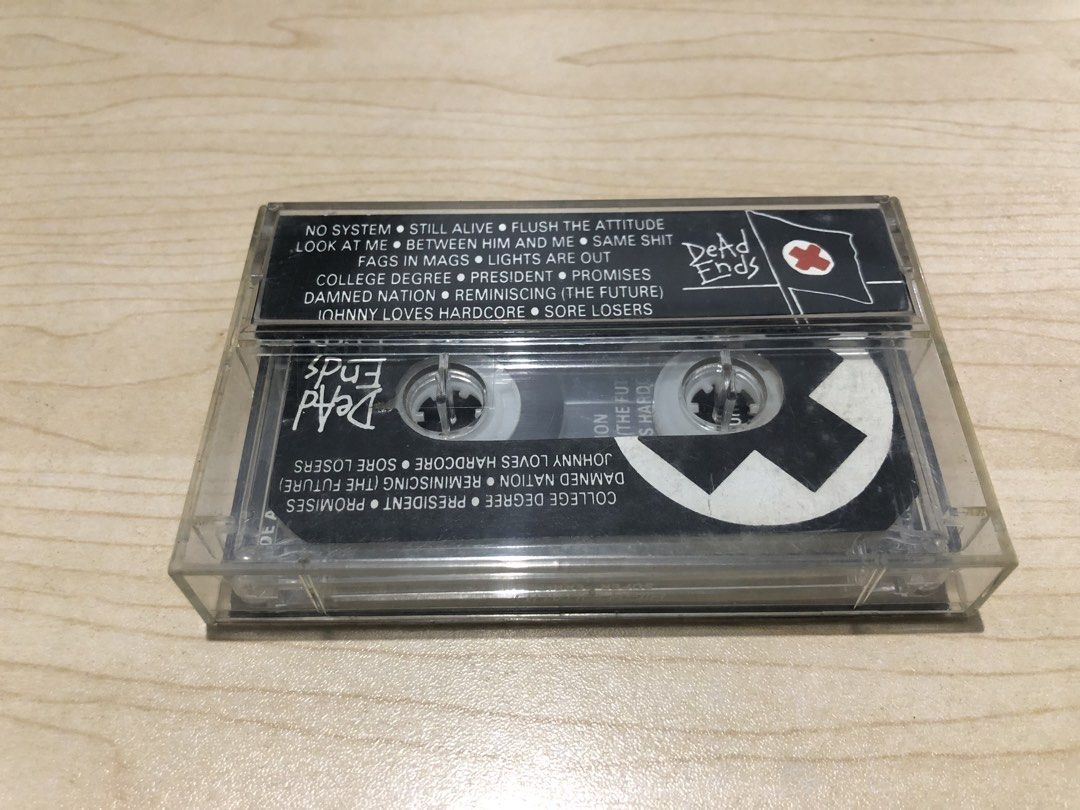 Dead Ends - Damned Nation Cassette Tape (Category: CDs & DVDs) located in Manila. Submitted by kulabot1516 (Listing ID 1465535521, Image 2). Description: - Item: Dead Ends - Damned Nation Cassette Tape - Catalog Number: DE-03 - Genre: Pinoy Punk Rock - Key Tracks: No System, Still Alive, Flush The Attitude, Johnny Loves Hardcore - Inclusion: Standard clear plastic case with full J-card insert and printed tape reels - Condition: Good vintage condi