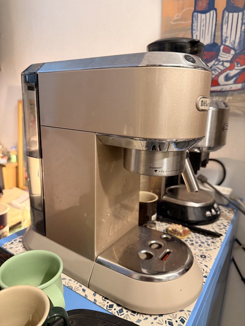 DeLonghi Dedica Espresso Machine Set with Accessories (Category: Coffee Machines & Makers) located in Mandaluyong City. Submitted by ohayouclub (Listing ID 1465438699, Image 2). Description: - Model: DeLonghi Dedica Espresso Maker - Color: Champagne Gold - Condition: Fully functional, normal signs of exterior use, clean and intact water tank - Included Accessories: - Two portafilters - Multiple filter baskets - Solid metal tamper - Milk frothing 
