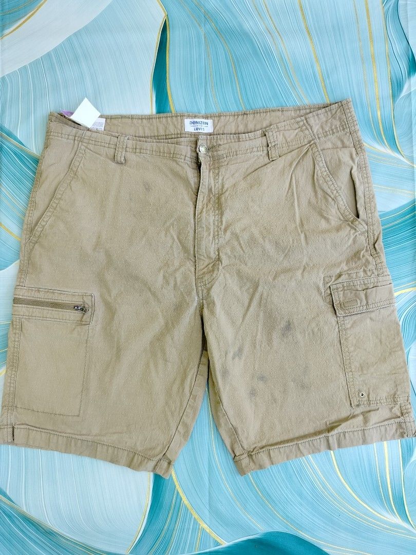 Denizen from Levi's Khaki Cargo Shorts Size 40 (Category: Shorts) located in Manila. Submitted by gerald_quinto (Listing ID 1465482482, Image 1). Description: - Brand: Denizen from Levi's - Color: Khaki - Size: Waist 40 / Hip 102cm - Material: Machine washable cotton blend - Closure: Button closure with zip fly and branded hardware - Pockets: Multiple utility pockets, including a secure left-leg zipper cargo pocket and back button pockets - Condi