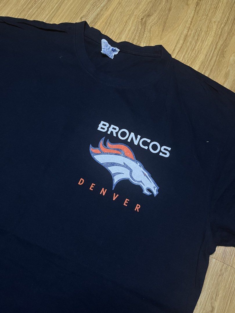 Denver Broncos NFL 22x31 (Category: Tshirts & Polo Shirts ) located in Cebu City. Submitted by guttathreads (Listing ID 1465429798, Image 3). Description: - Item: Denver Broncos NFL T-Shirt - Color: Dark Blue - Size: XXL (JHK tag) - Design: Small logo on front chest, large graphic print on the back - Fit: Classic fit, short sleeves - Condition: Great for game days and casual wear.