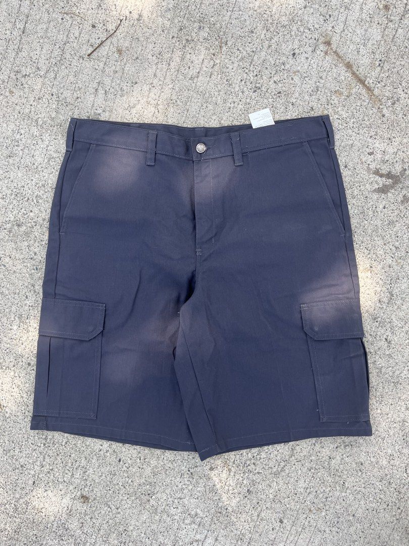 Dickies Cargo Charcoal Work Pants Size 36x22 LO12 (Category: Trousers) located in Cebu City. Submitted by guttathreads (Listing ID 1465458555, Image 2). Description: - Brand: Dickies - Color: Charcoal grey - Size: Waist 35 - Material: 65% polyester, 35% cotton - Origin: Made in Guatemala - Condition: Brand new with tags and inside care instructions - Style: Solid dark color, ideal for everyday workwear or casual use.