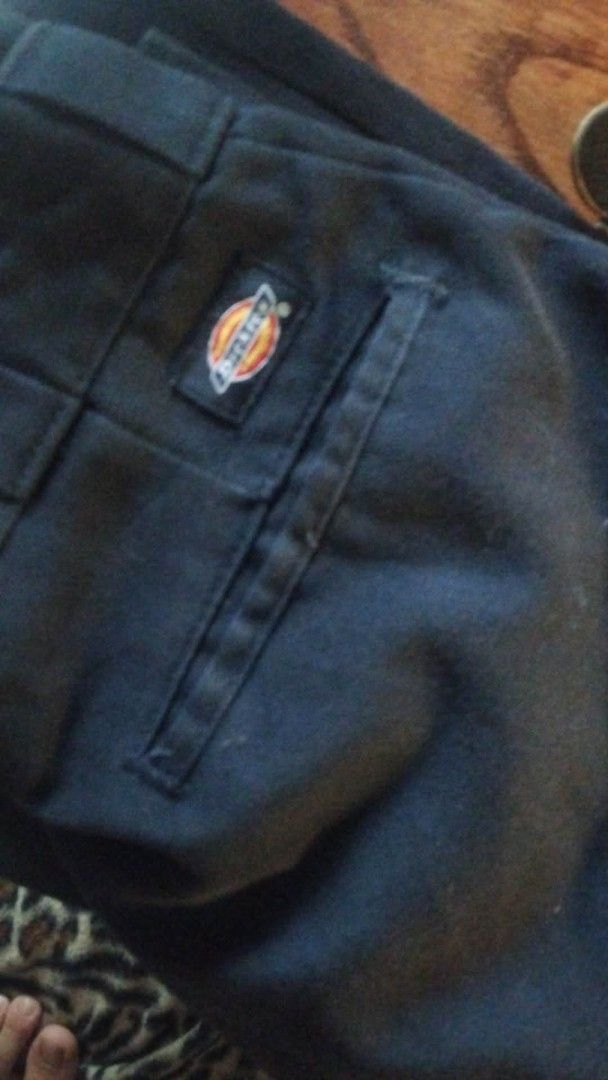 Dickies Work Pants (Category: Trousers) located in Manila. Submitted by lawrence_escutin (Listing ID 1465547947, Image 2). Description: - Size: 30 on tag 31 waist on dime - Color: navy blue - Brand: Dickies - Classic workwear style with standard belt loops - Features rear welt pockets and signature logo patch above the right pocket - Durable, heavy-duty fabric built for daily wear.