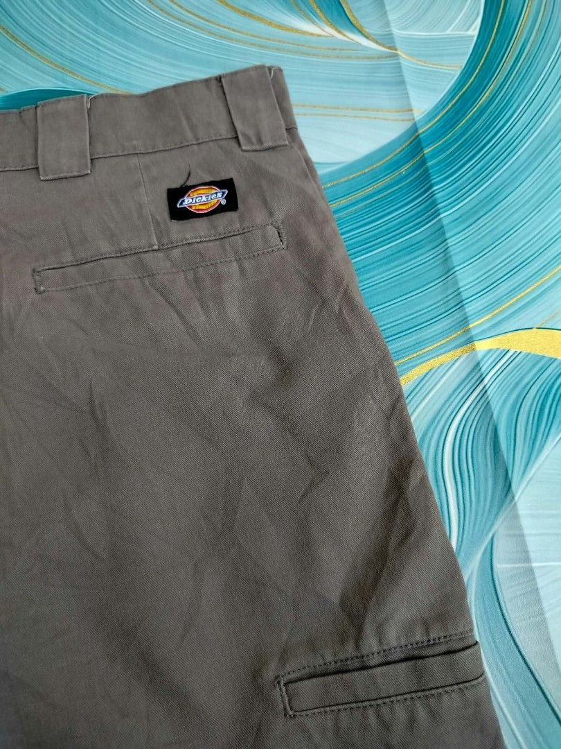 Dickies Work Shorts Brown Size 38 (Category: Shorts) located in Manila. Submitted by virgiliosa38485 (Listing ID 1465498723, Image 3). Description: - Brand: Dickies - Color: Brown - Size: 38 -Length 23 - Material: 65% polyester, 35% cotton - Features: Multiple utility and back pockets with button closure, iconic logo patch above back pocket - Condition: Good, with small dark stains near the hem on the front lower left leg.