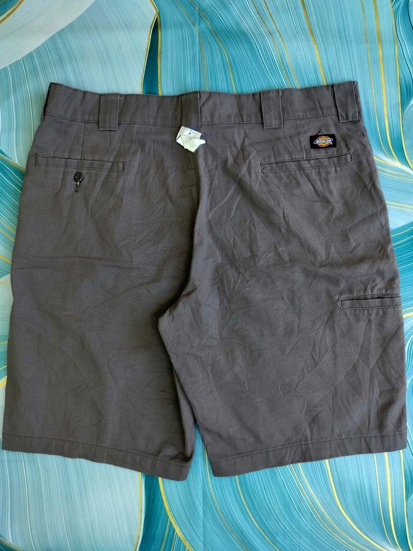 Dickies Work Shorts Brown Size 38 (Category: Shorts) located in Manila. Submitted by virgiliosa38485 (Listing ID 1465498723, Image 1). Description: - Brand: Dickies - Color: Brown - Size: 38 -Length 23 - Material: 65% polyester, 35% cotton - Features: Multiple utility and back pockets with button closure, iconic logo patch above back pocket - Condition: Good, with small dark stains near the hem on the front lower left leg.