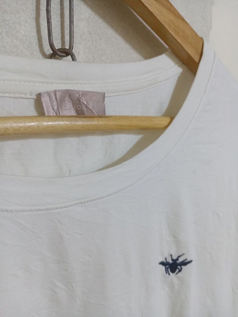 Dior White Bee Embroidered T-Shirt (Category: Shirts) located in Manila. Submitted by drip-from-thrift (Listing ID 1465578419, Image 2). Description: - Brand: Dior - Color: Classic White - Size: Small - Design: Signature embroidered bee logo on the chest - Fit: Regular fit with classic crew neck and short sleeves - Condition: Clean, great everyday staple that easily matches any outfit.